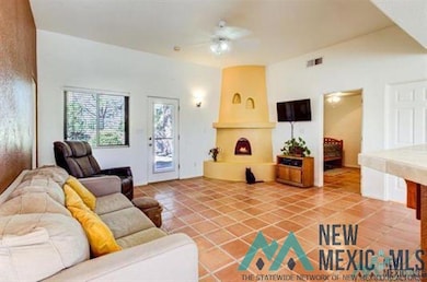 Living area with light tile patterned flooring and a ceiling fan