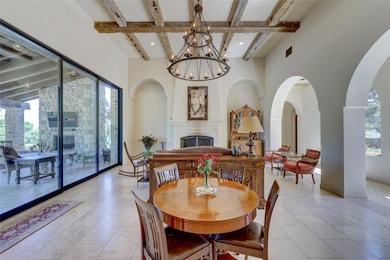Dining area with a tile fireplace, beam ceiling, 