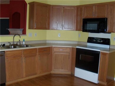 The kitchen overlooks the living room. laminate fl
