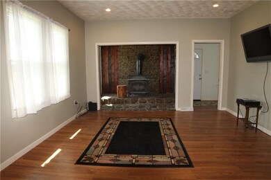 Spacious living room features a rustic alcove with
