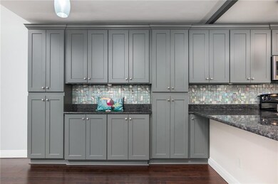 The gorgeous kitchen cabinetry extends in to the d