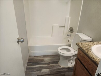 Full bath featuring wood finished floors, vanity,