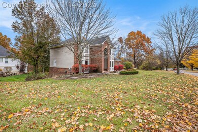 View of property exterior with a yard and brick siding
