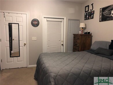 Master bedroom with large walk in closet and door 