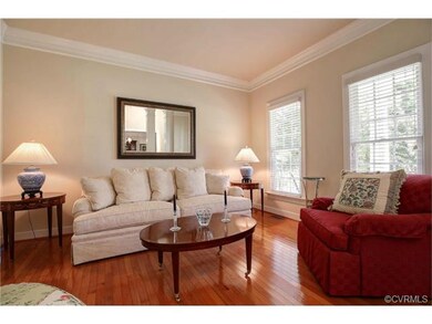 Living Room with Crown Molding and Hardwood Floors