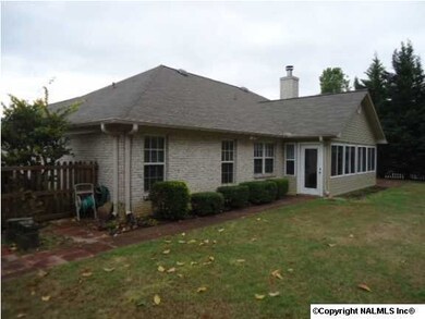 Back view of house with sun room on the back