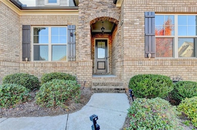 Doorway to property featuring brick siding