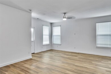 Empty room with baseboards, a ceiling fan, visible