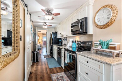Kitchen with black appliances and white cabinets