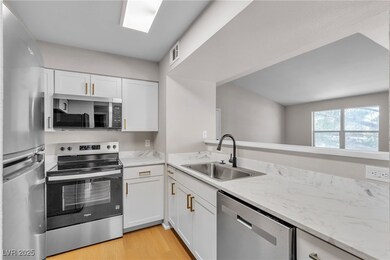 Kitchen featuring stainless steel appliances, a si