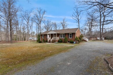 View of front facade featuring gravel driveway, br