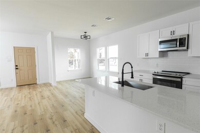 Kitchen featuring sink, light wood-type flooring, 