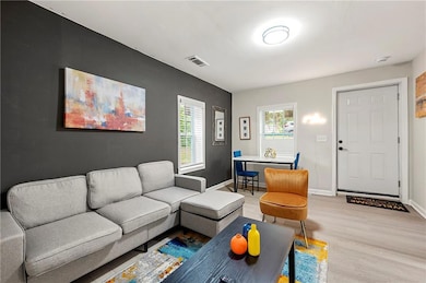 Living room with light wood finished floors and baseboards