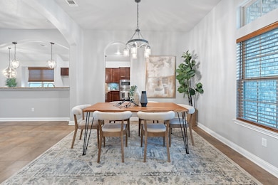 Dining area with a chandelier, arched walkways, a