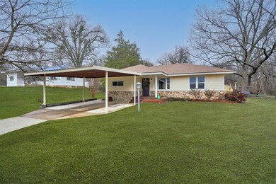 Ranch-style home featuring a carport and a front l