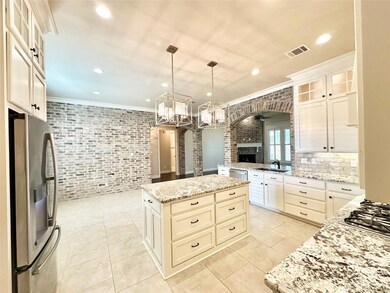 Kitchen with a center island, light stone counters