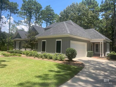 View of front facade featuring a garage and a front lawn