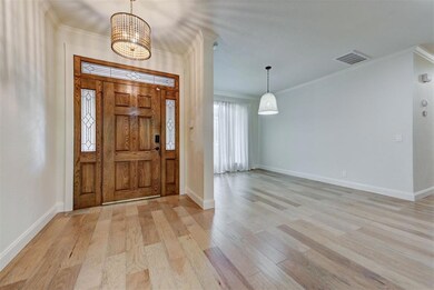 Entrance foyer with light wood-type flooring, orna