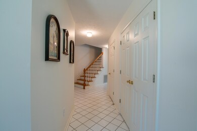 Hallway featuring light tile patterned flooring
