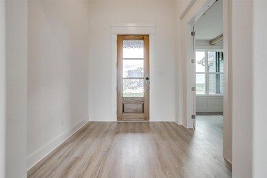 Foyer entrance with light wood-type flooring and a wealth of natural light