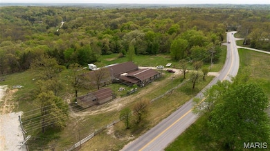 Birds eye view of property featuring a view of trees