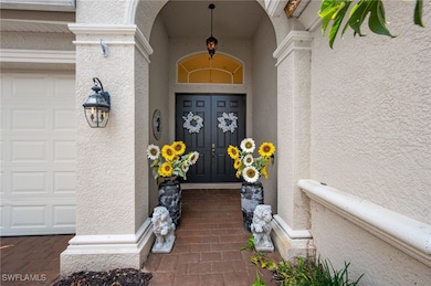 Property entrance featuring stucco siding and a ga