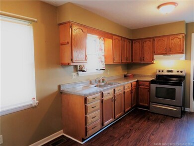 Newer oak cabinets and laminate flooring.
