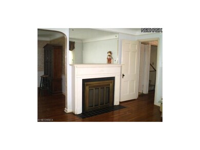 Large, sunny livingroom with corner windows and fireplace.