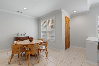 Dining room with ornamental molding, recessed lig