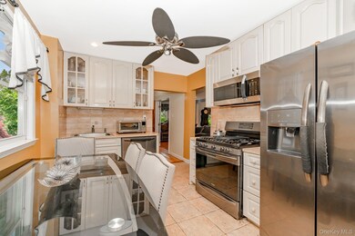 Kitchen with appliances with stainless steel finishes, backsplash, plenty of natural light, light tile patterned floors, and recessed lighting