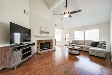 Entertain guests or enjoy a quiet family movie night in this comfortable space with an expansive rear-facing window shaded by 2-inch blinds, beautiful wood-look laminate floors, freshly textured & painted walls, and easy access to the adjoining kitchen.