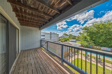 Balcony featuring view of pool