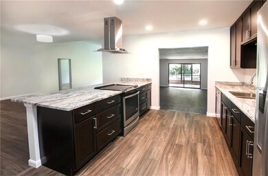 Kitchen with view to family room and screened pati