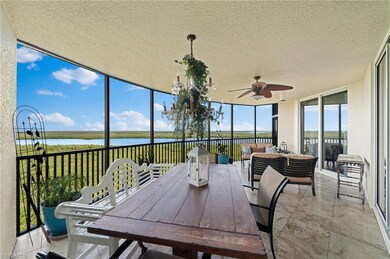 Sunroom / solarium with a water view and ceiling f