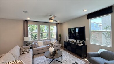 Living area featuring plenty of natural light, wood finished floors, a ceiling fan, and recessed lighting