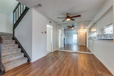 Unfurnished living room with ceiling fan, hardwood