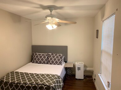 Spacious bedroom with a comfortable queen-sized be