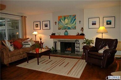 Living room with wood burning fireplace plus hardw