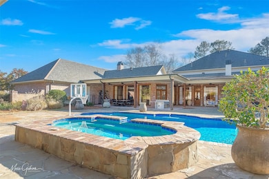 View of swimming pool with an in ground hot tub, a