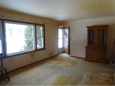 Main level living room with foyer/ closet, coved c