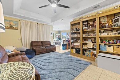 Tiled living room with a raised ceiling, ceiling f