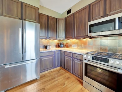 Kitchen featuring stainless steel appliances, ligh