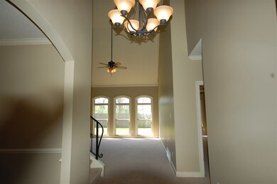 Grant entry with the two story entry hall opening up to the dining room (left) and the family room ahead.