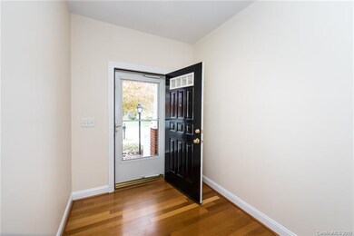 Entry foyer with hardwood floors.
