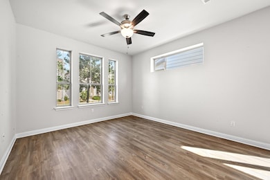 Empty room featuring wood finished floors and ceiling fan