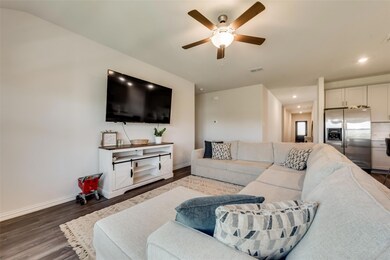Living room featuring dark hardwood / wood-style flooring and ceiling fan