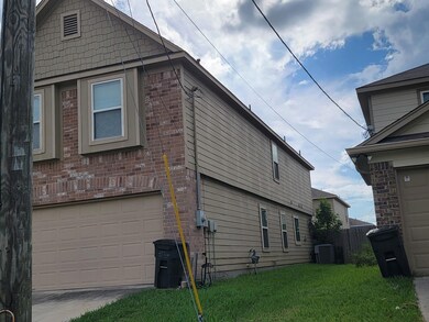 View of side of property with a garage, a lawn, and central AC unit