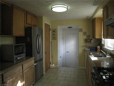 Hall off the kitchen leads to the 1/2 bath and 2 c