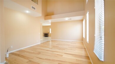 Unfurnished living room with a towering ceiling, l