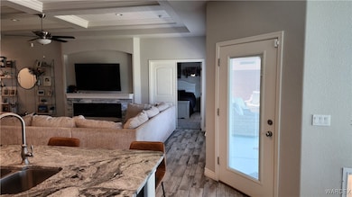 Kitchen with coffered ceiling, hardwood / wood-sty